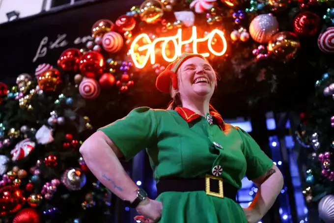 A smiling Christmas Town elf at the Grotto